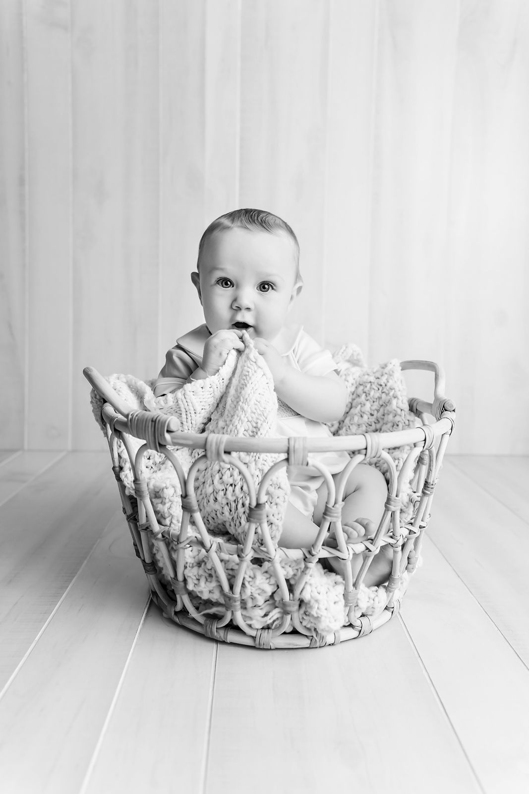 6 month old baby in a basket during a studio Babies 1st Year Milestone Session for a client from Newberry SC.
