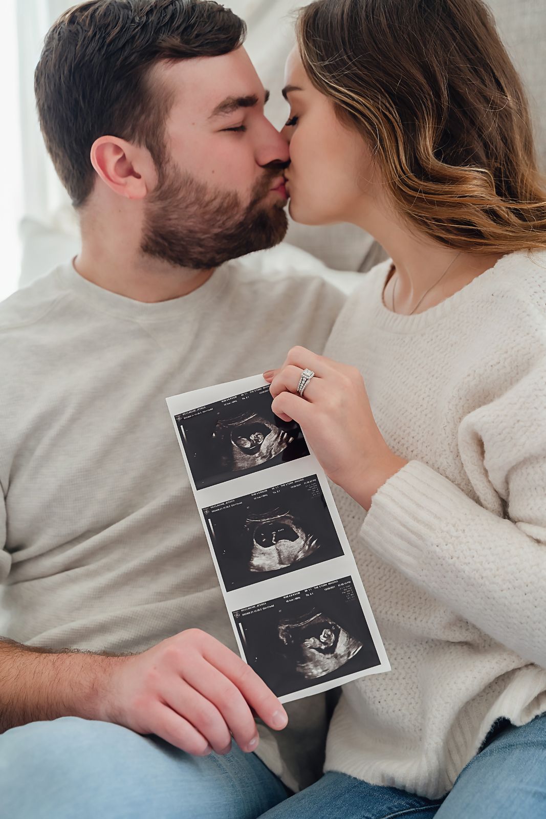 Close-up image of couple holding their ultrasound image during an in-home pregnancy announcement session in Lexington South Carolina.