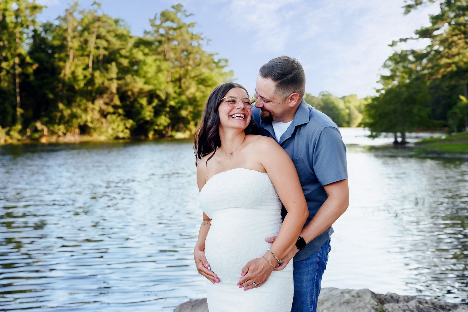 Stunning outdoor scenic backlit maternity portrait with water behind the couple at Gibson Pond Park in Lexington South Carolina.