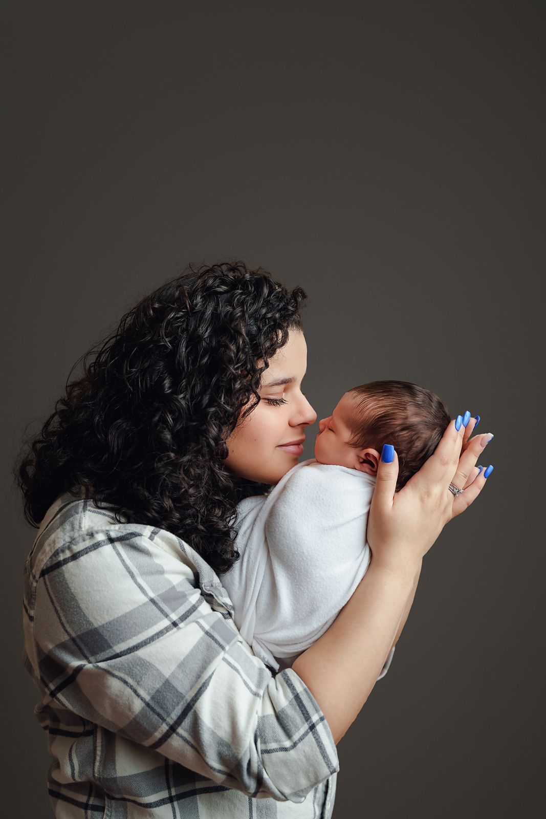 Mom touching noses with her newborn baby girl during a studio newborn session for clients from Columbia SC.