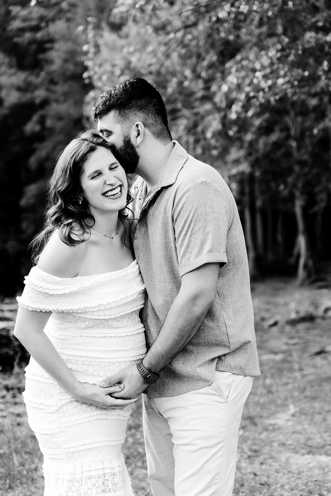 Mom to be laughing as Dad whispers in her ear during a Lexington SC Maternity Portrait Session.