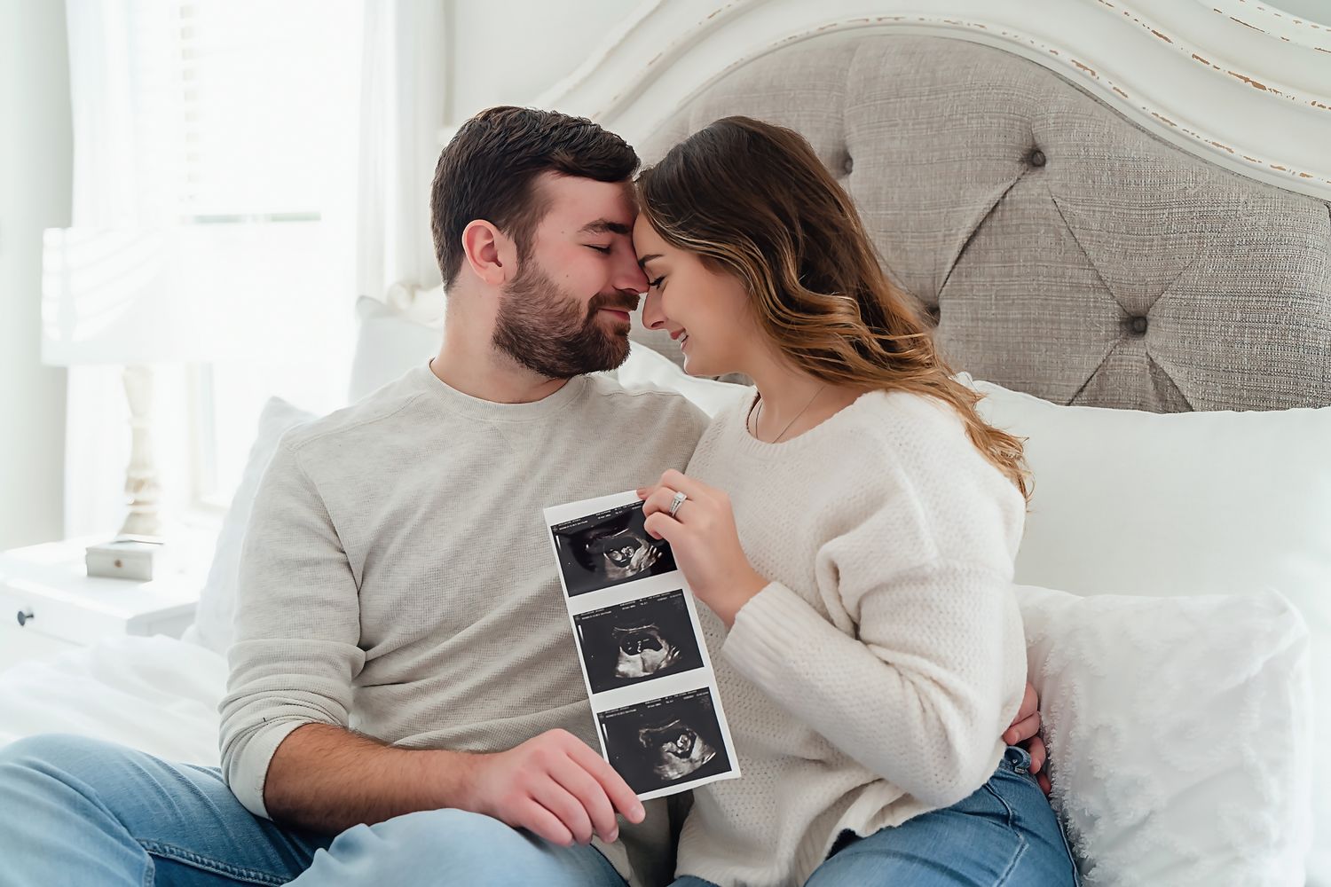 Pregnancy Announcement Portrait of a couple holding up their ultrasound pictures during a Columbia SC Lifestyle Session.