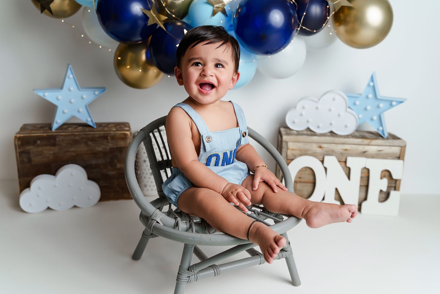 A sweet celestial cake smash session featuring blue, white and gold for a little guys 1st Birthday Cake Smash Session in Lexington SC.