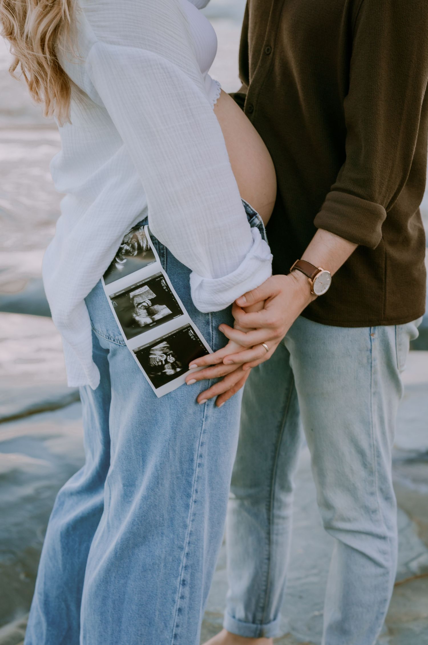 Brisbane maternity photographer — expectant couple holding hands and ultrasound photo during outdoor maternity session, Joy Filled Photograp