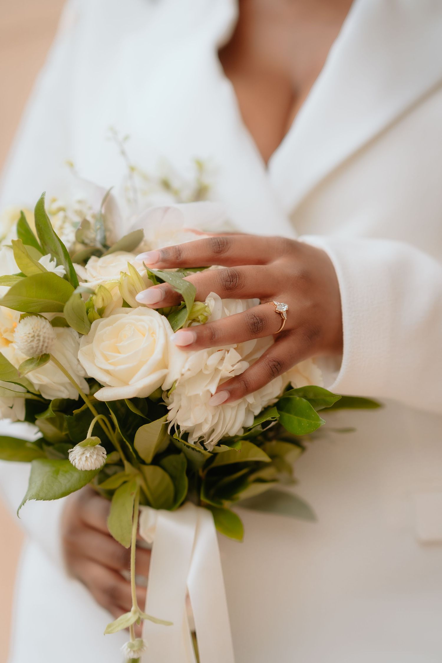 Brisbane wedding photographer — close-up of bride's hands holding a delicate white and pink bouquet on her wedding day, Joy Filled Photograp