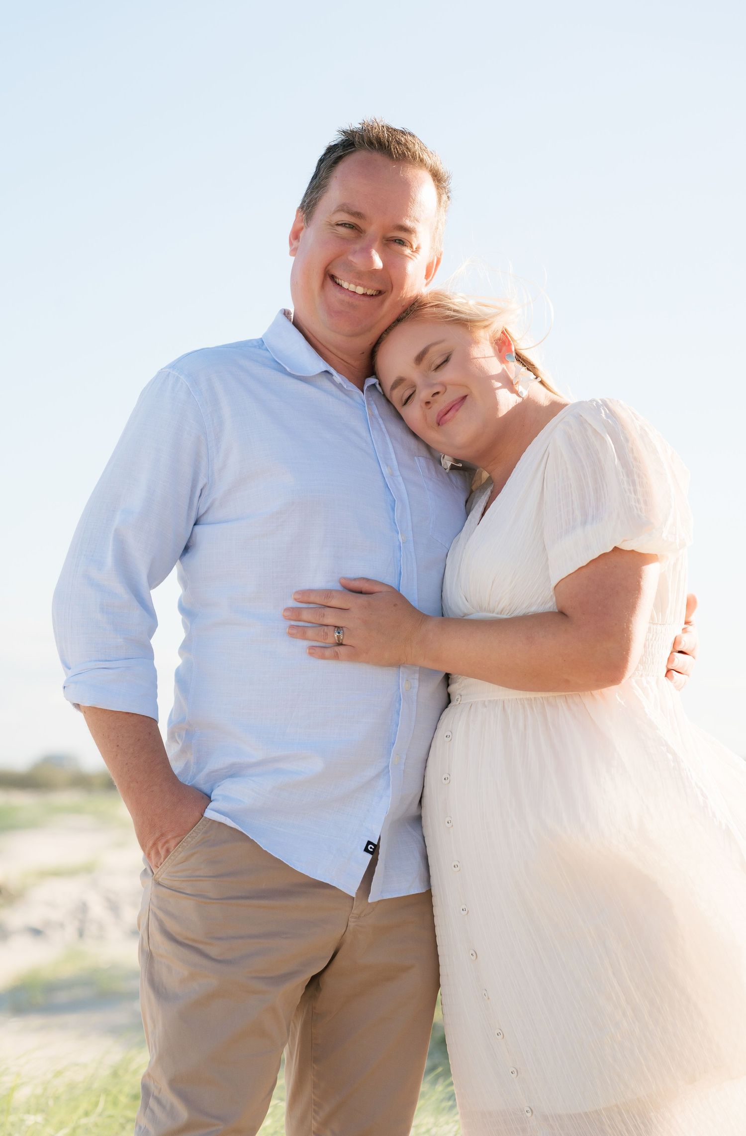 Brisbane couples photographer — man and woman leaning together smiling at an outdoor location, relaxed and natural couple portrait by Joy Fi