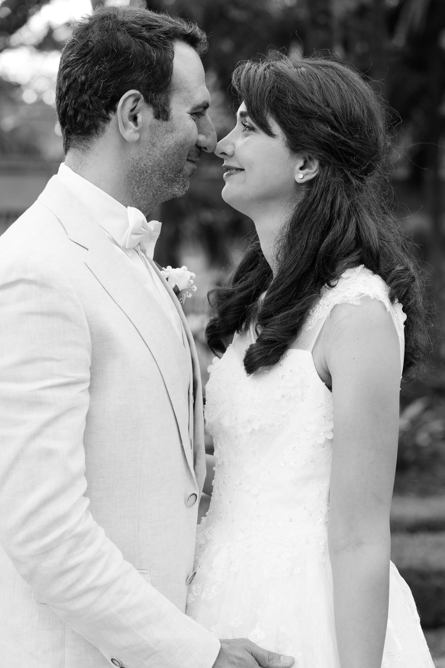 Brisbane wedding photographer — black and white portrait of groom tenderly leaning in to kiss bride, deeply connected and romantic wedding m