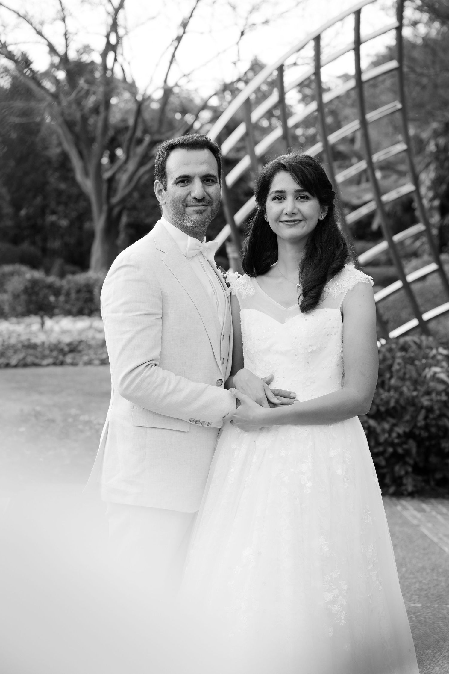 Brisbane maternity photographer — black and white close-up of couple's hands holding ultrasound scan, intimate and emotional pregnancy annou