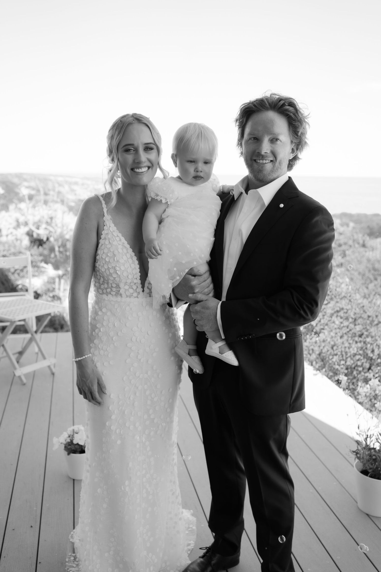 Brisbane wedding photographer — black and white portrait of bride and groom smiling together on their wedding day, genuine and joyful moment