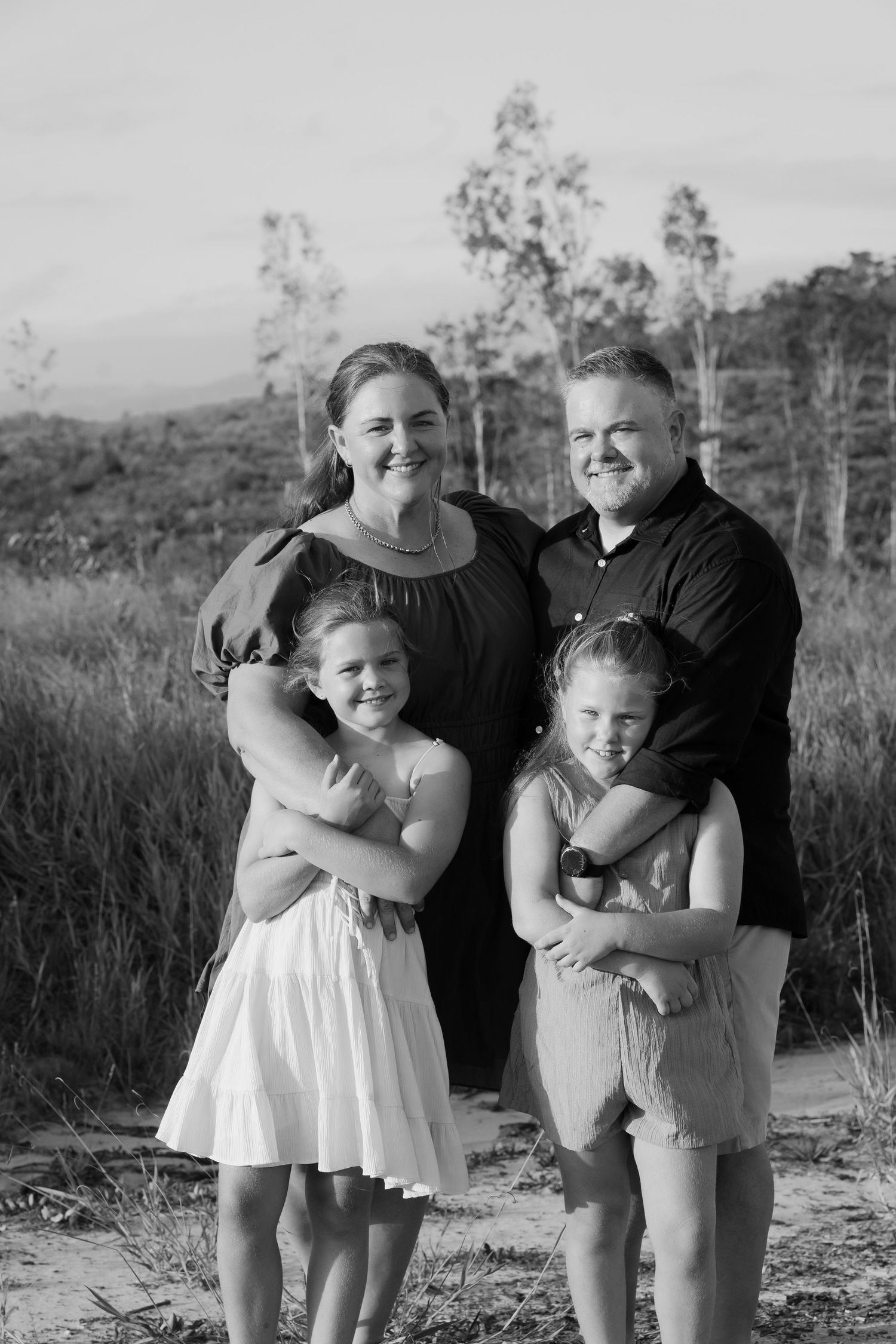Brisbane family photographer — black and white portrait of mother with children smiling together, beautiful natural family portrait by Joy F