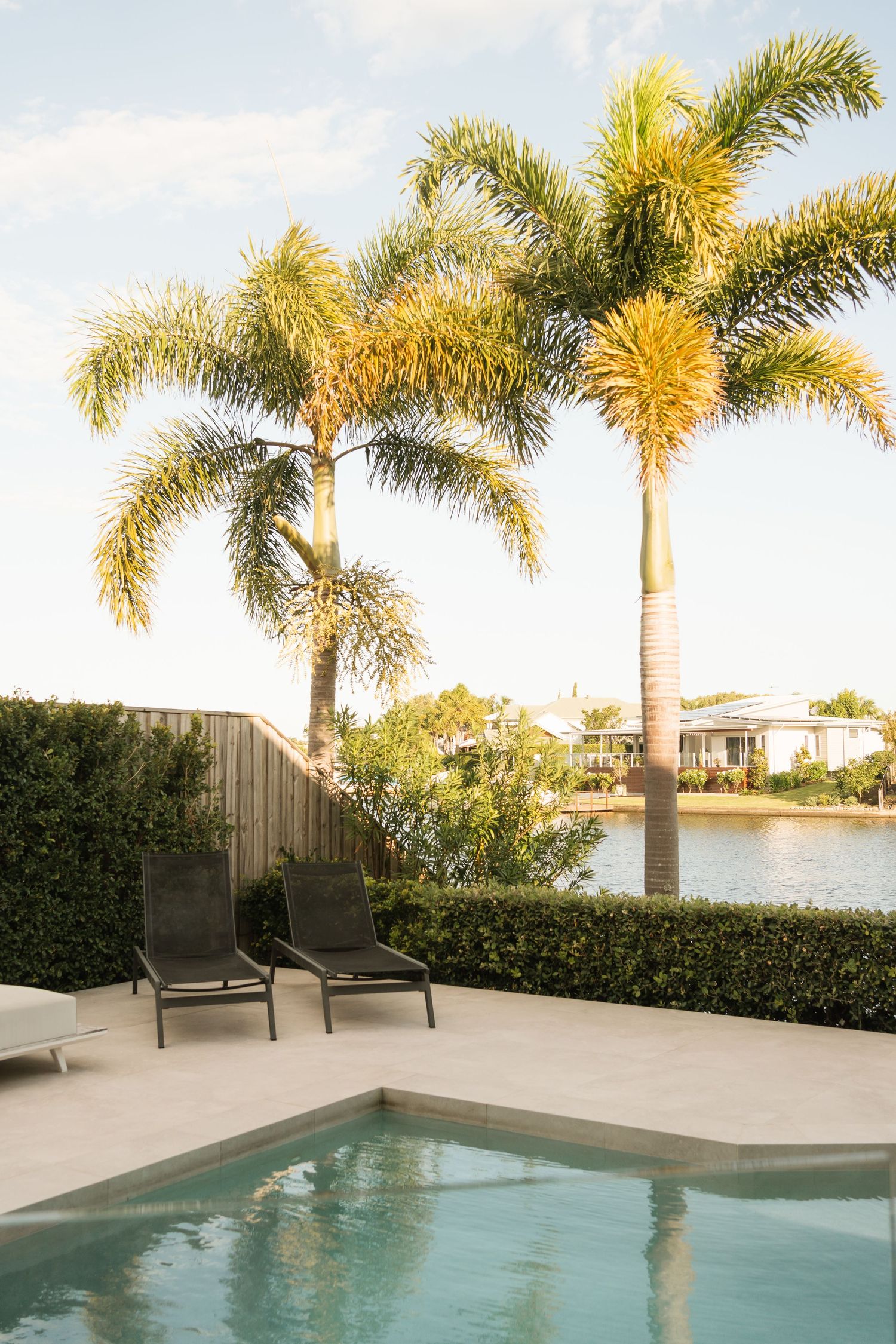 Brisbane wedding photographer — stunning outdoor wedding venue with pool and palm trees, captured by Joy Filled Photography