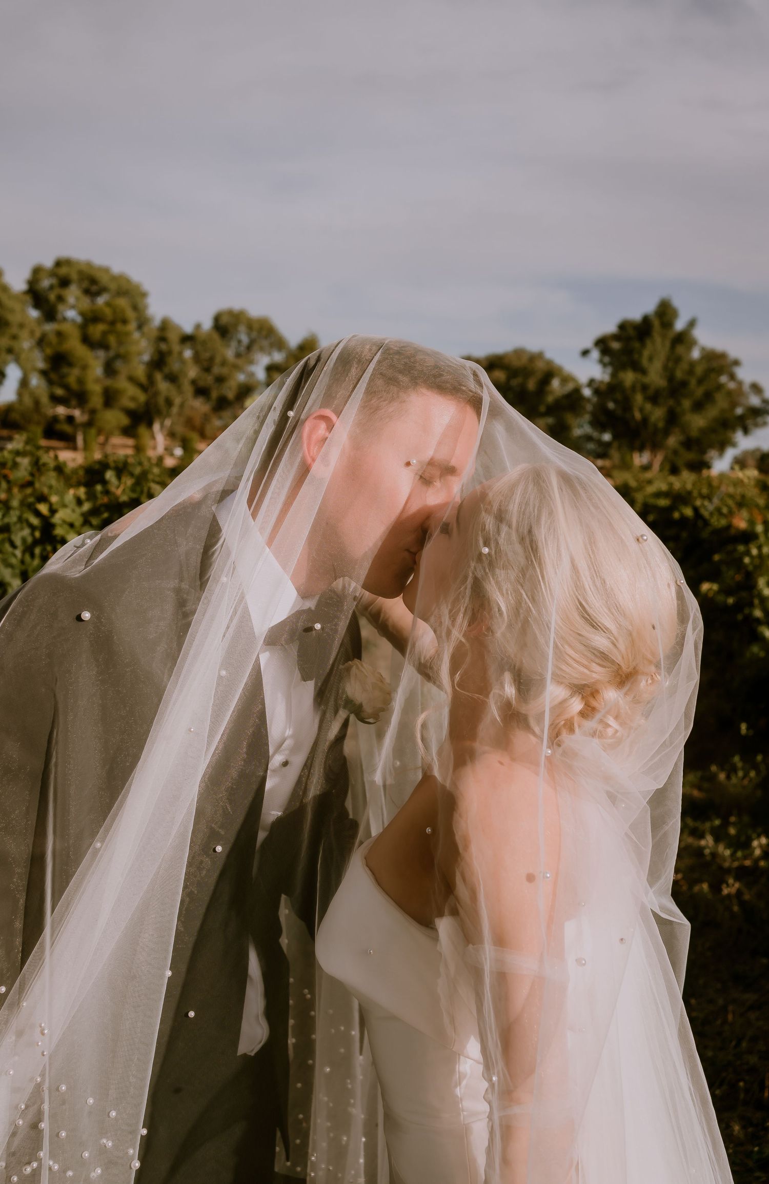 Brisbane wedding photographer — ethereal portrait of bride with veil flowing in the wind in a rural setting, dreamy and editorial bridal sho