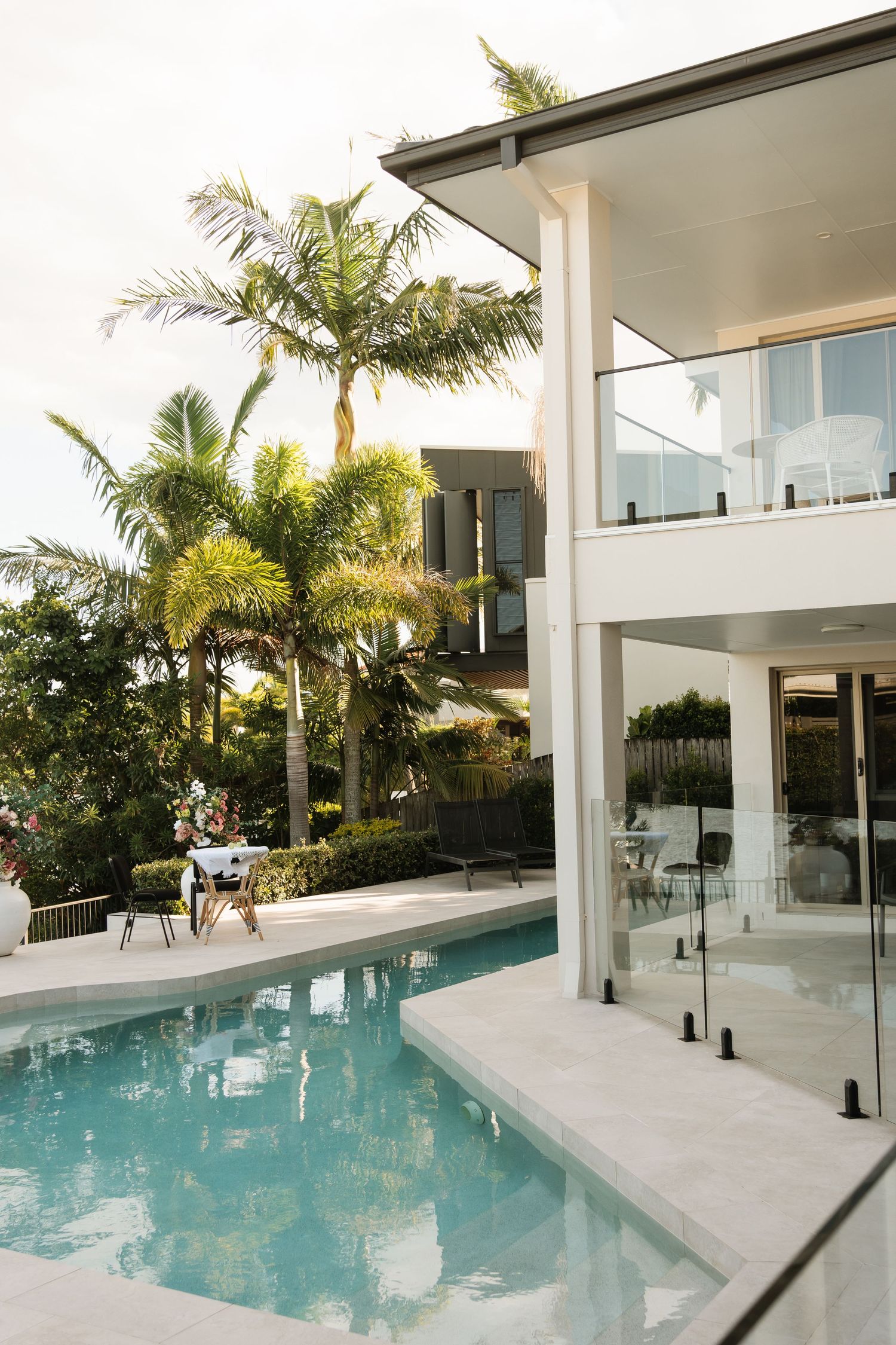 Brisbane wedding photographer — elegant outdoor wedding venue with pool, palm trees and manicured gardens, Joy Filled Photography Queensland