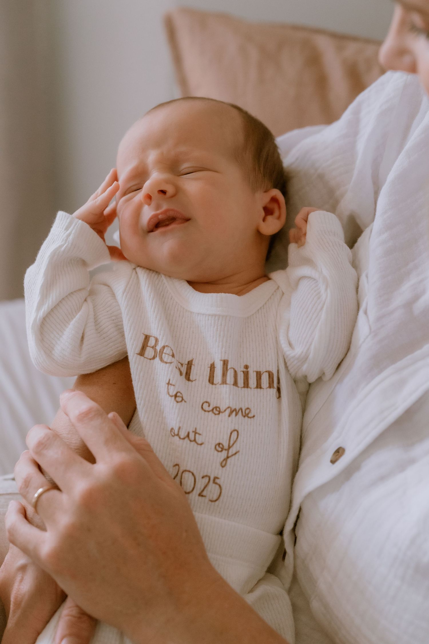 Brisbane newborn photographer — adorable sleeping newborn in a personalised onesie, delicate lifestyle portrait from in-home session by Joy