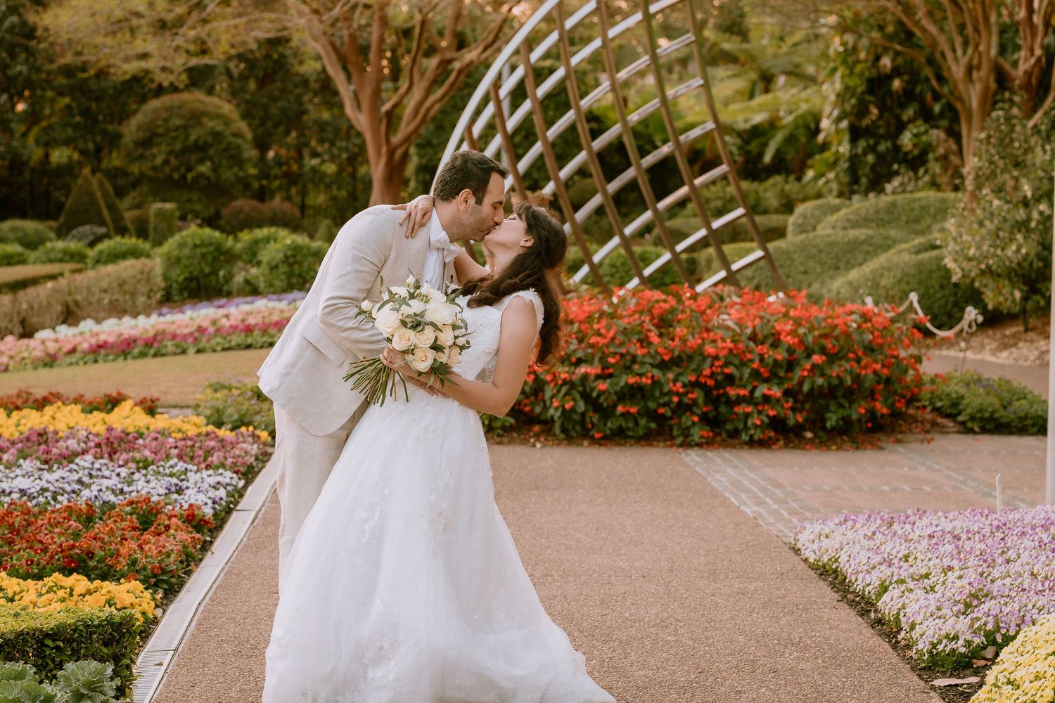 Brisbane elopement photographer — bride walking along a scenic coastal path in a white flowy dress, dreamy and romantic elopement moment by
