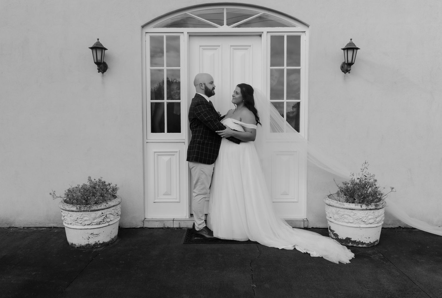 Brisbane wedding photographer — bride and groom arriving at a beautiful chapel venue entrance, romantic wedding day portrait by Joy Filled P