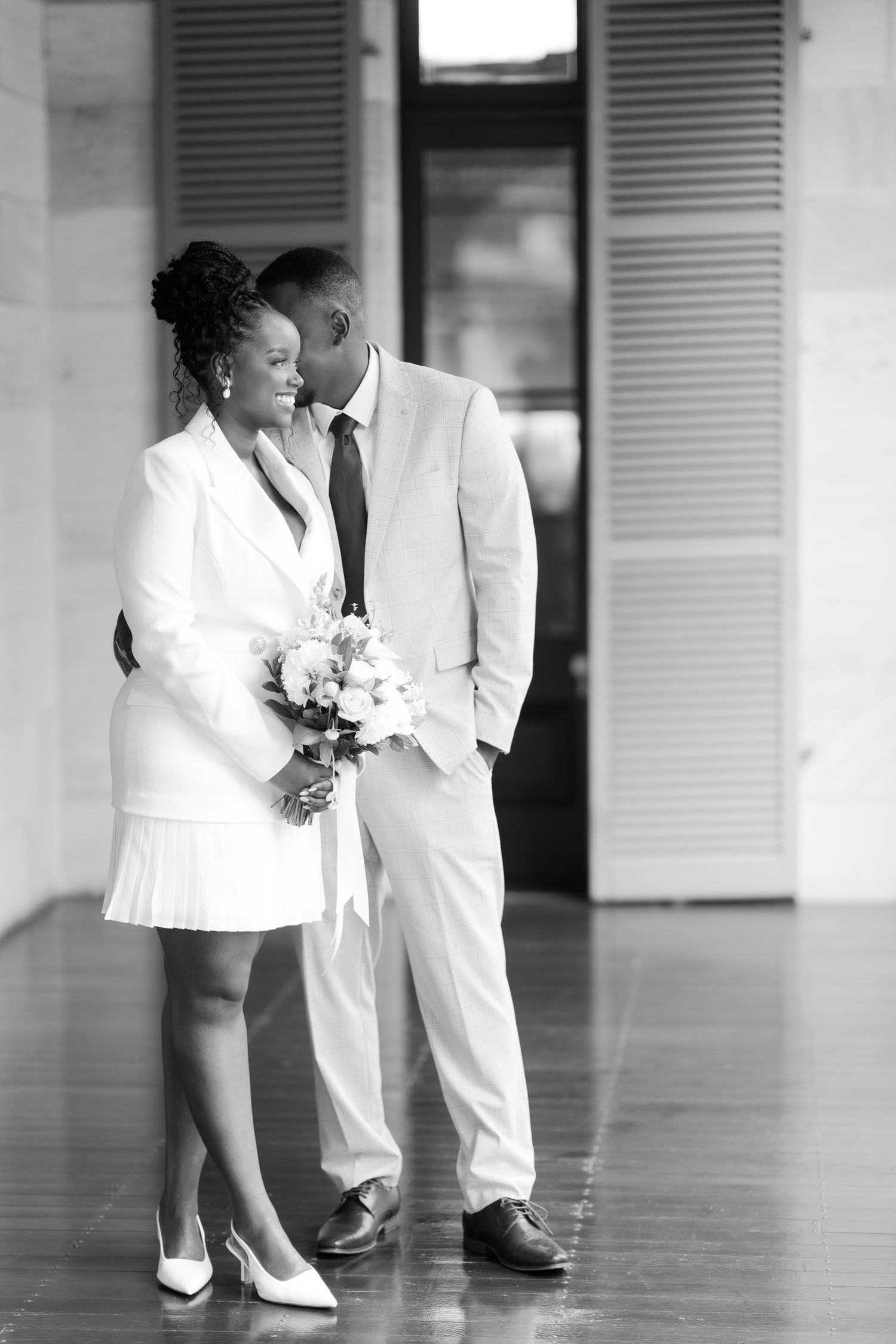 Brisbane elopement photographer — black and white portrait of couple walking together at a venue, elegant and intimate wedding moment by Joy