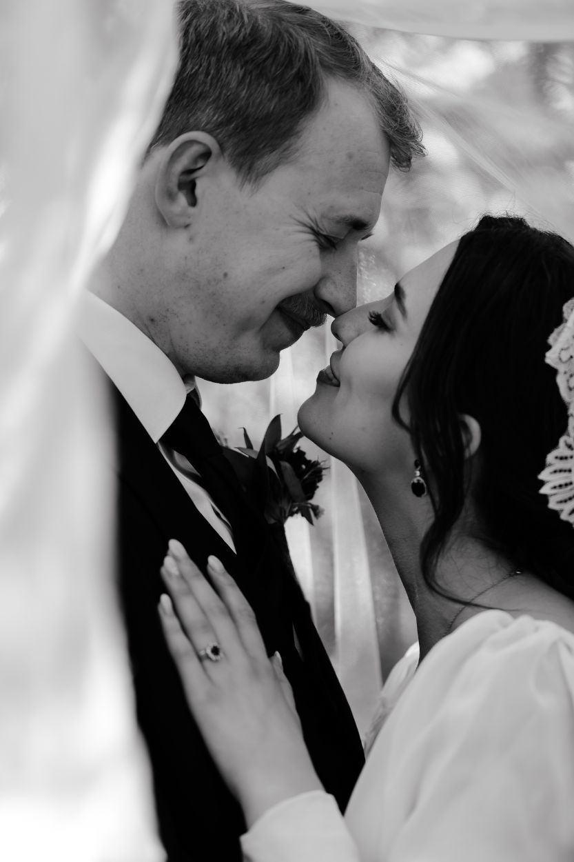 A tender black and white wedding photo showing an intimate moment between newlyweds in Mississauga.