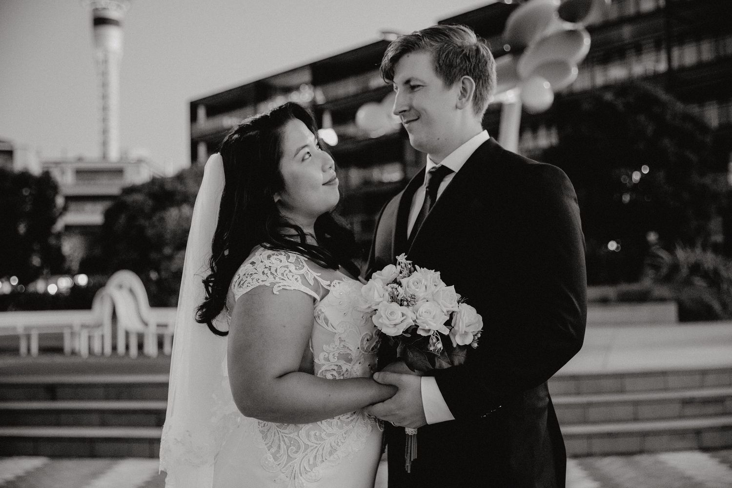 A black and white wedding photo collage showing romantic moments between a couple in formal attire.