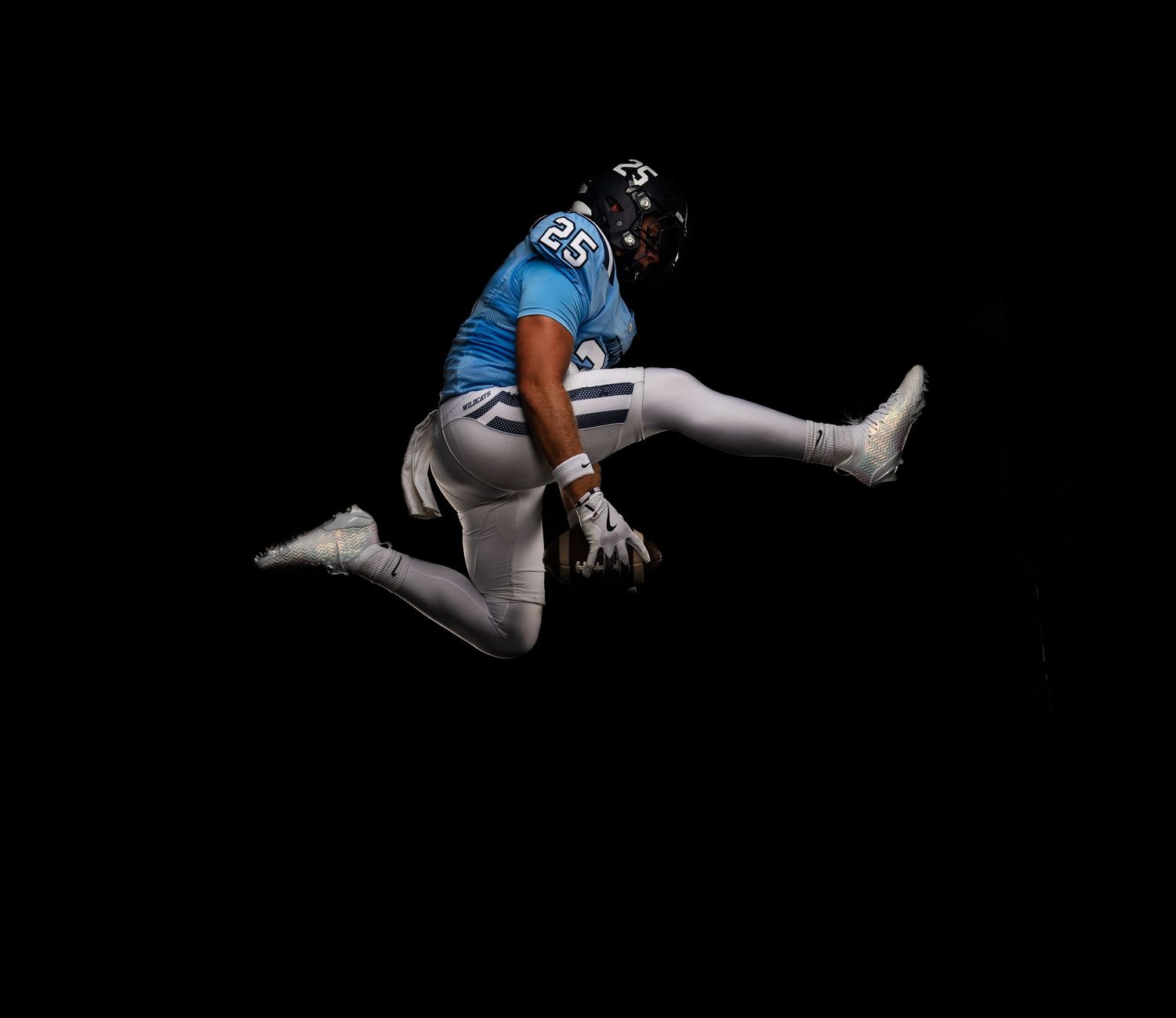 Athletic legs and feet performing jumping sequence against black background.