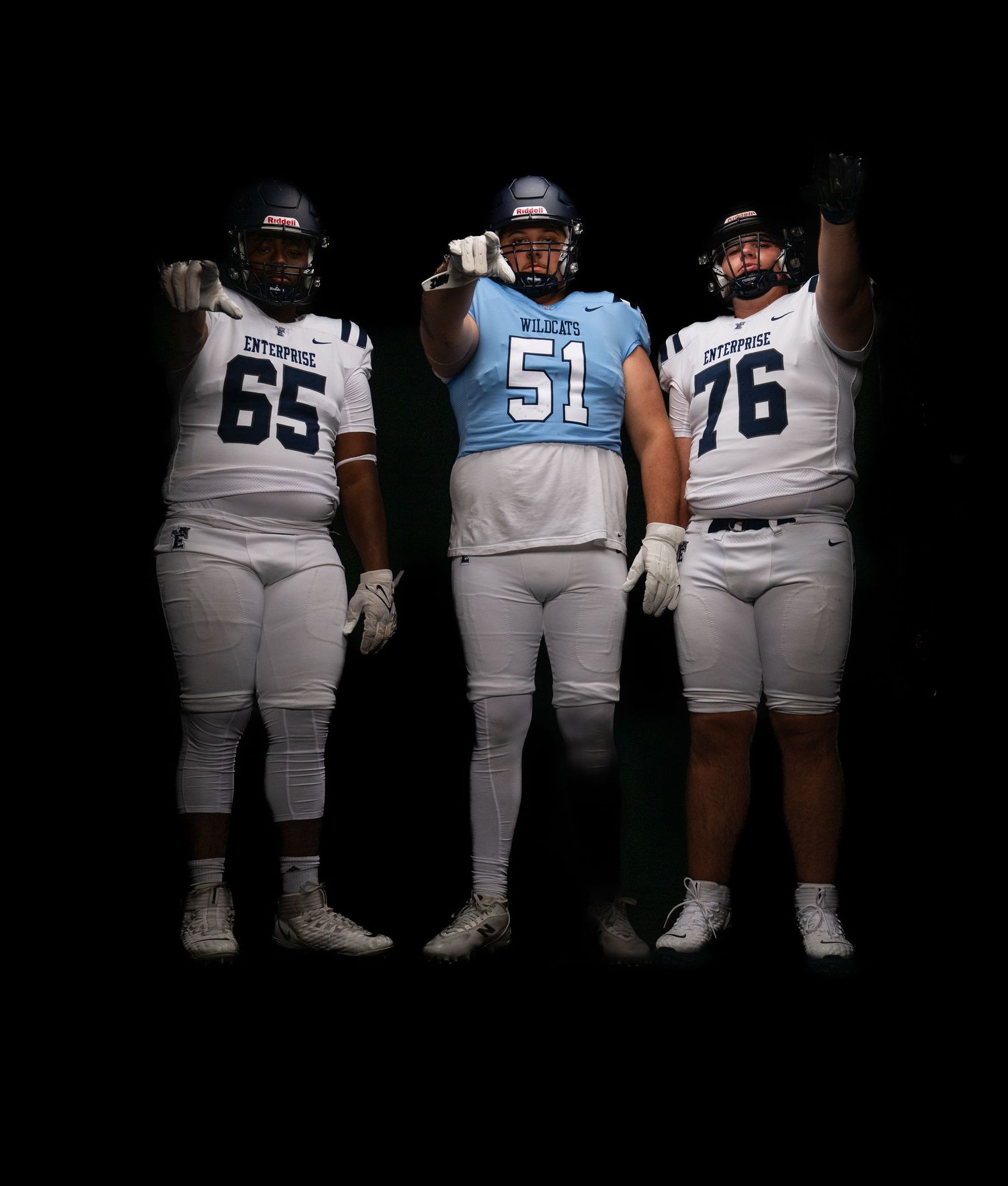 Three football players in Enterprise and Wilson uniforms, numbers 65, 51, and 76, posing dramatically against a black background.