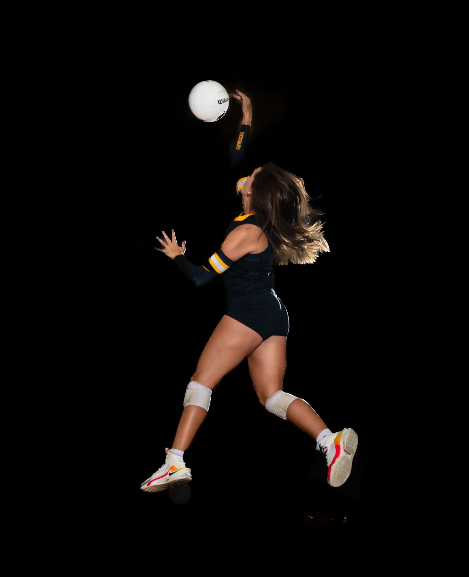 Dynamic volleyball player diving to save ball during intense match.