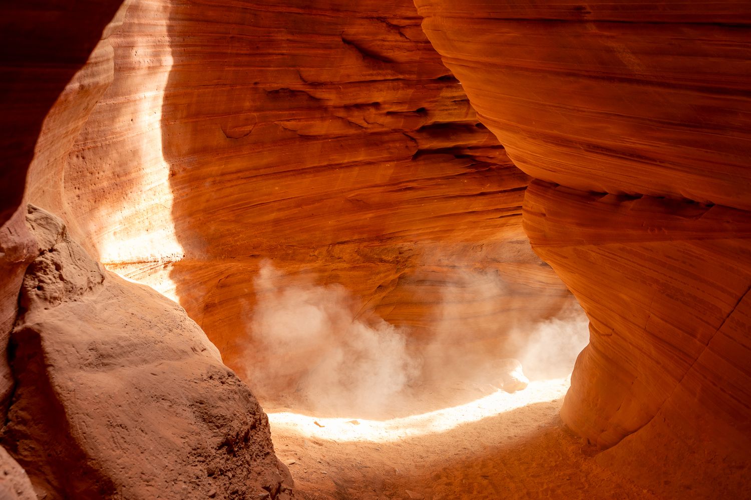 Sunbeams illuminate red sandstone walls in Antelope Canyon creating ethereal light effects.