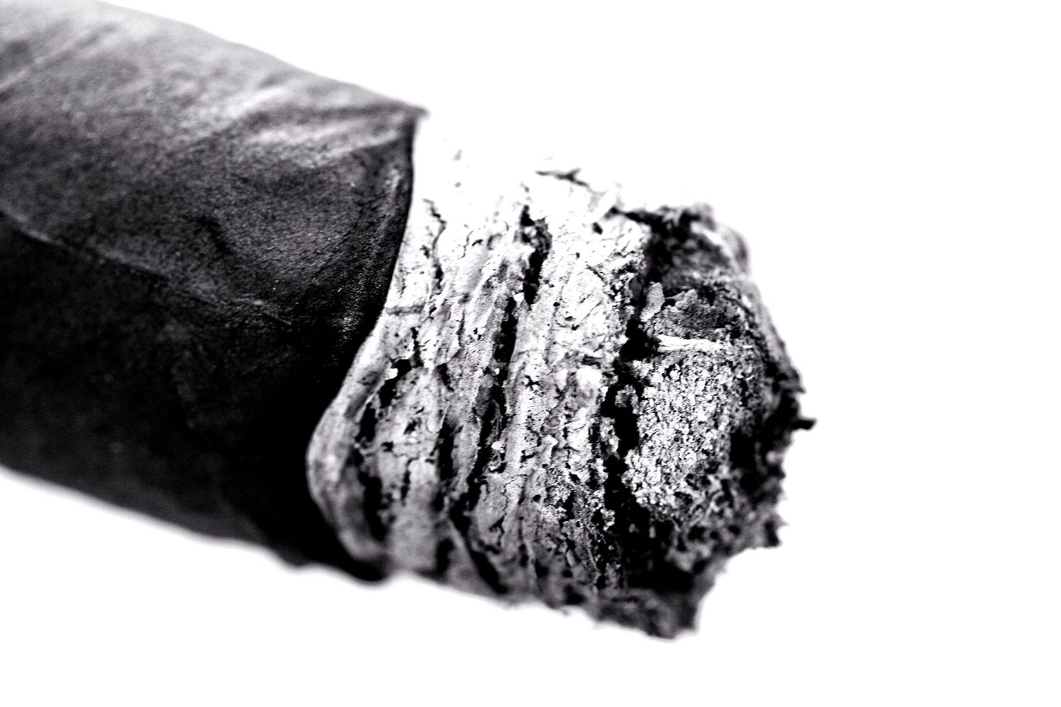 High contrast black and white close-up of rough textured surfaces fading into white.