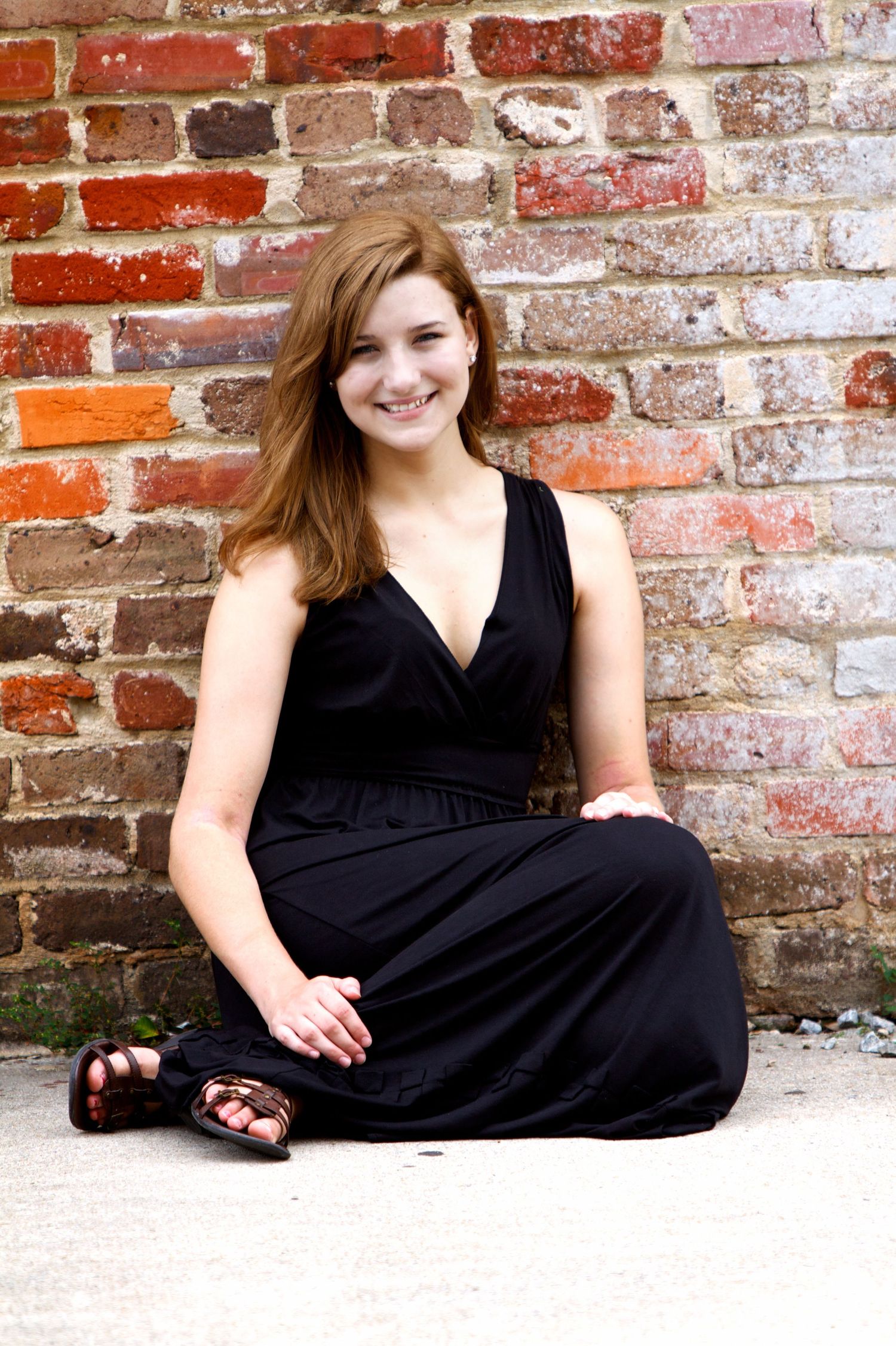 Portrait series against weathered brick wall featuring black dress and casual poses.