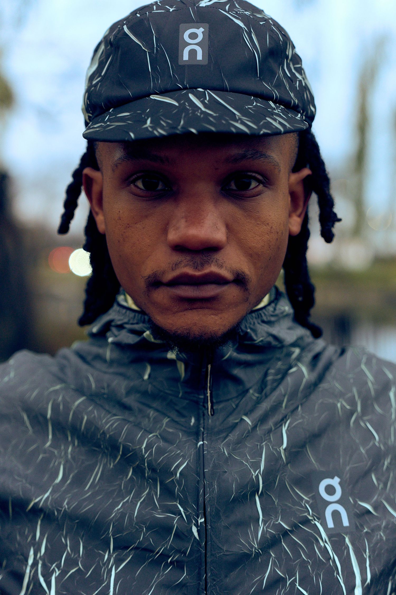 Close-up shot of reflective athletic wear jacket with geometric pattern details.