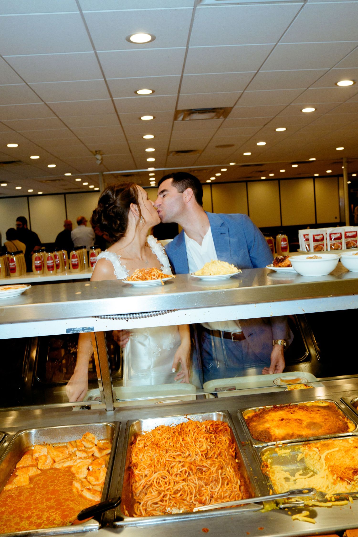 Buffet line with various pasta dishes and hot food selections at a restaurant.