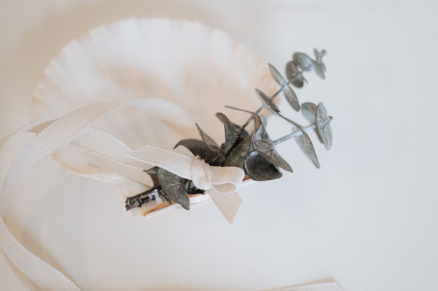 A row of origami paper cranes in white and gray tones arranged in a minimalist artistic composition.