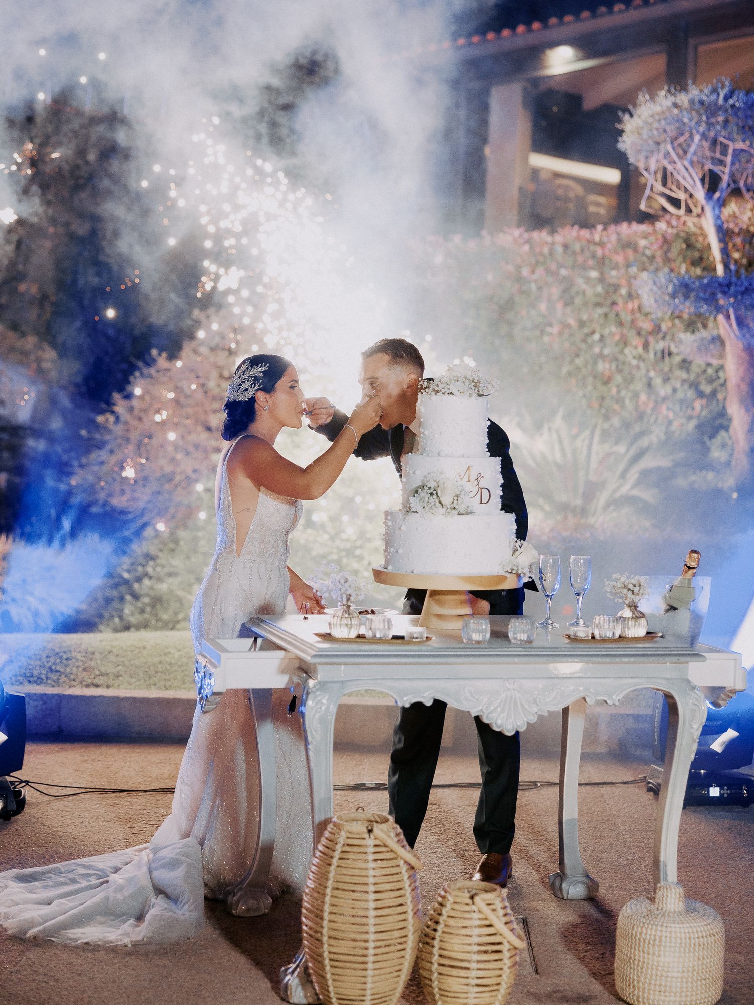 A romantic wedding scene at dusk with lanterns and sparklers creating a magical atmosphere during an intimate celebration.