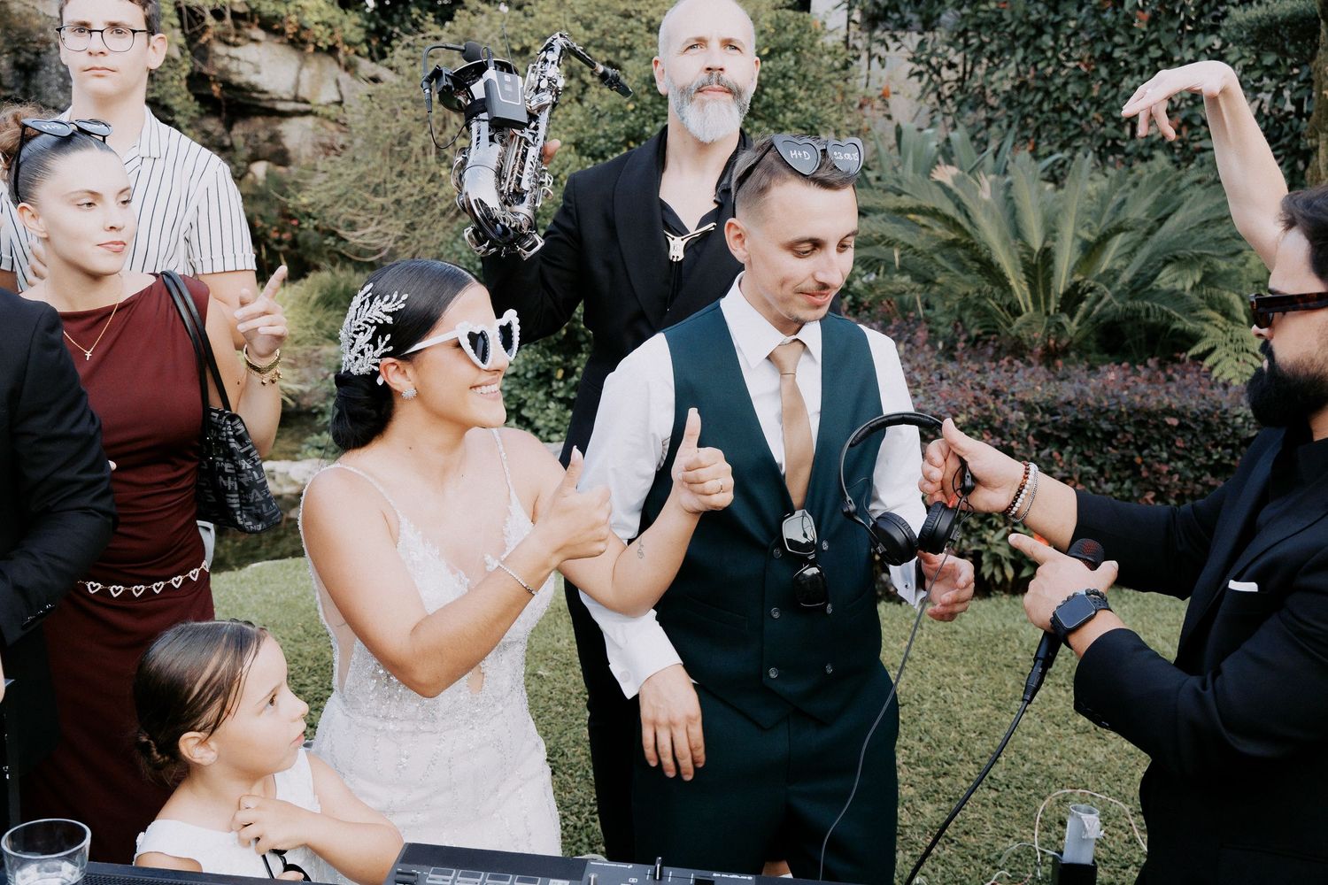 A series of candid wedding celebration moments showing guests dancing and celebrating at an outdoor reception.