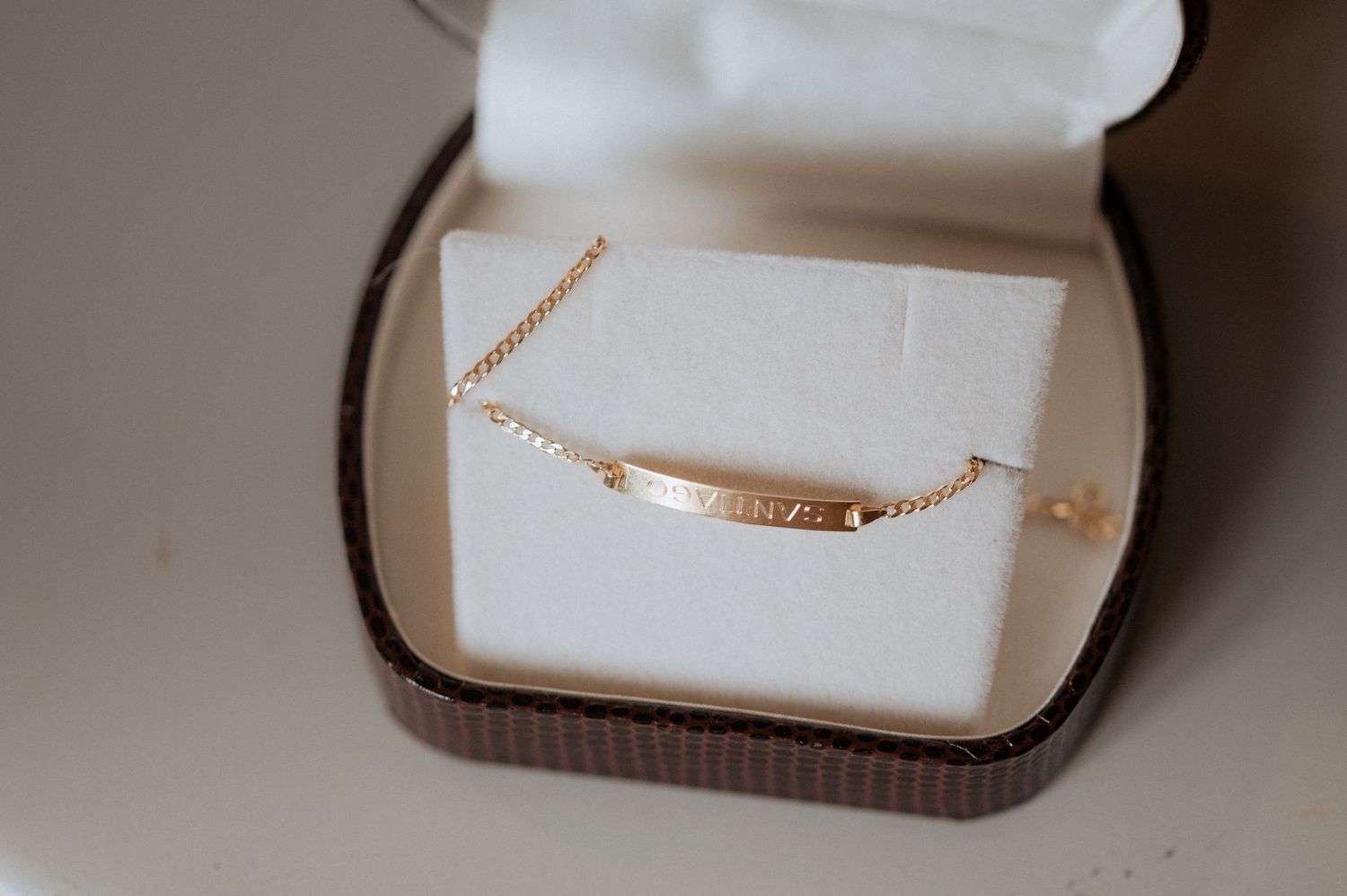 A series of six jewelry boxes showing the same gold necklace from different angles and distances.