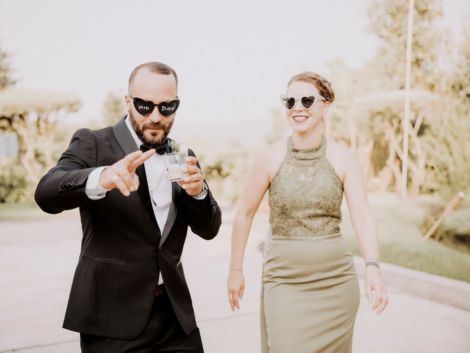 Wedding couple poses playfully in a sequence of photos showing them walking and dancing together outdoors.