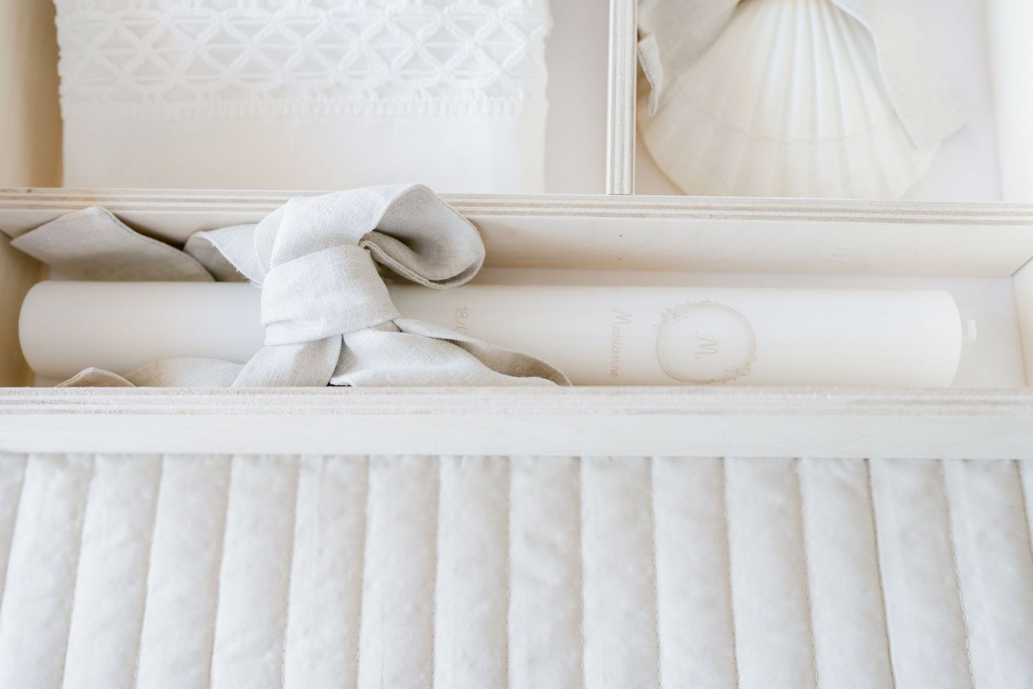 White crown molding and ornate architectural details adorn the ceiling of an elegant interior space.