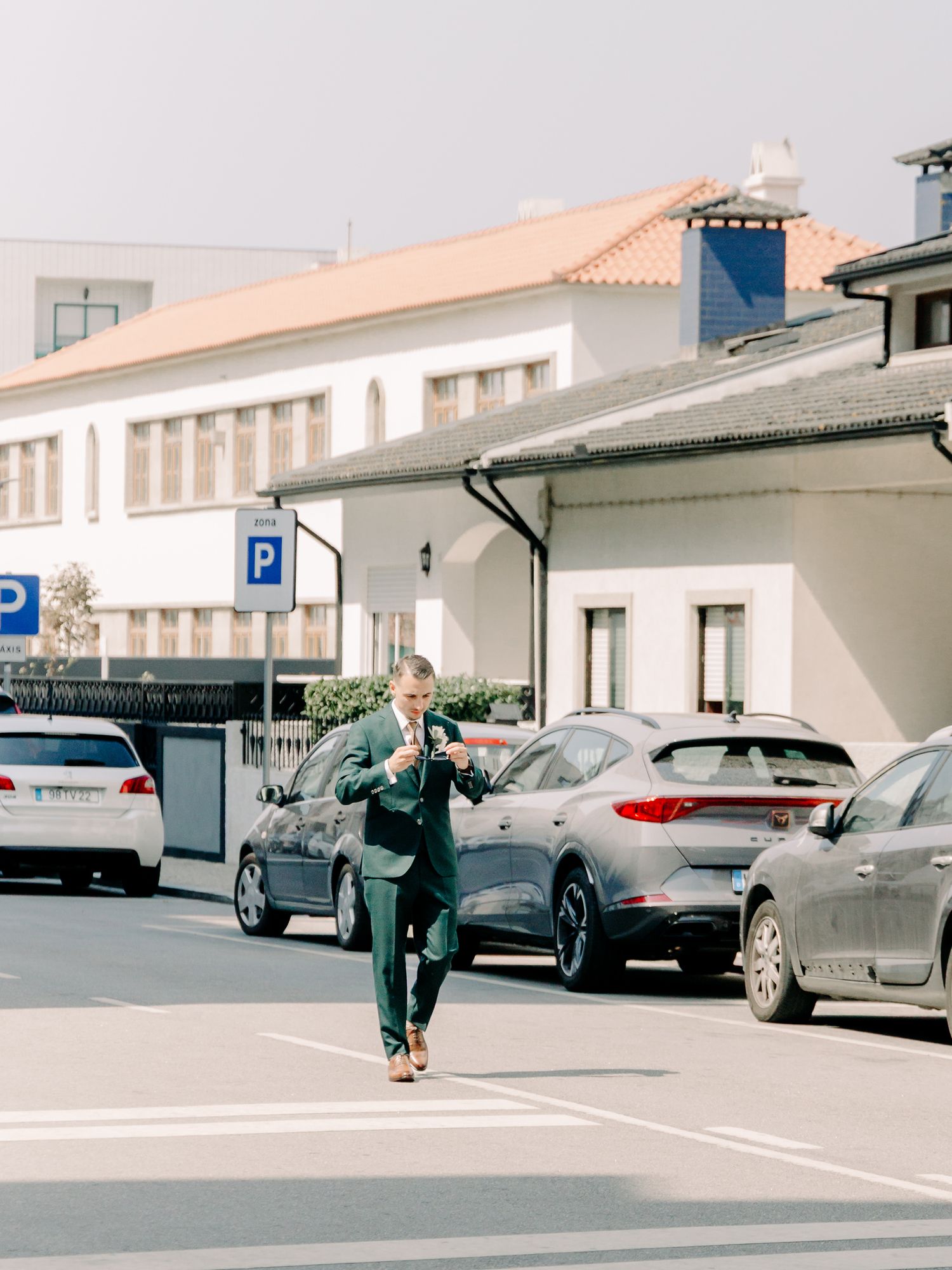 A sequence of photos showing a person skateboarding in a parking lot between parked cars.