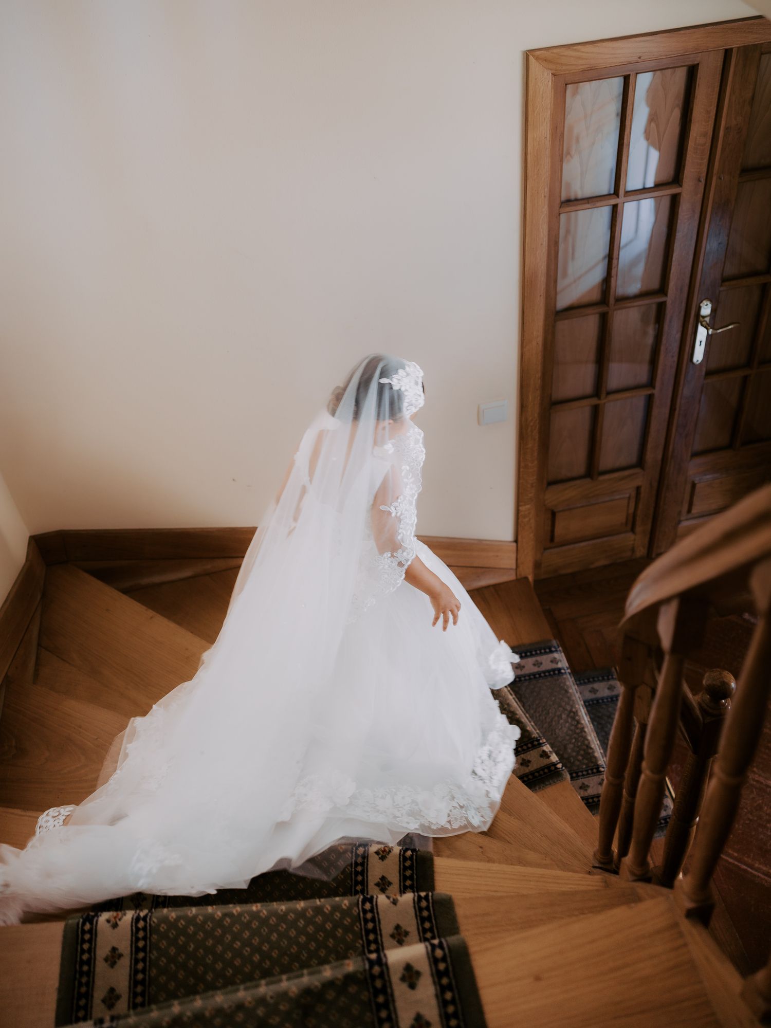 A flowing white wedding dress billows elegantly across wooden stairs in a series of artistic photographs.