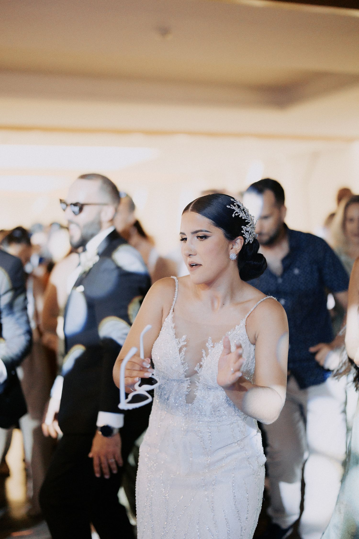 A series of wedding reception photos showing people dancing and celebrating in an indoor venue.