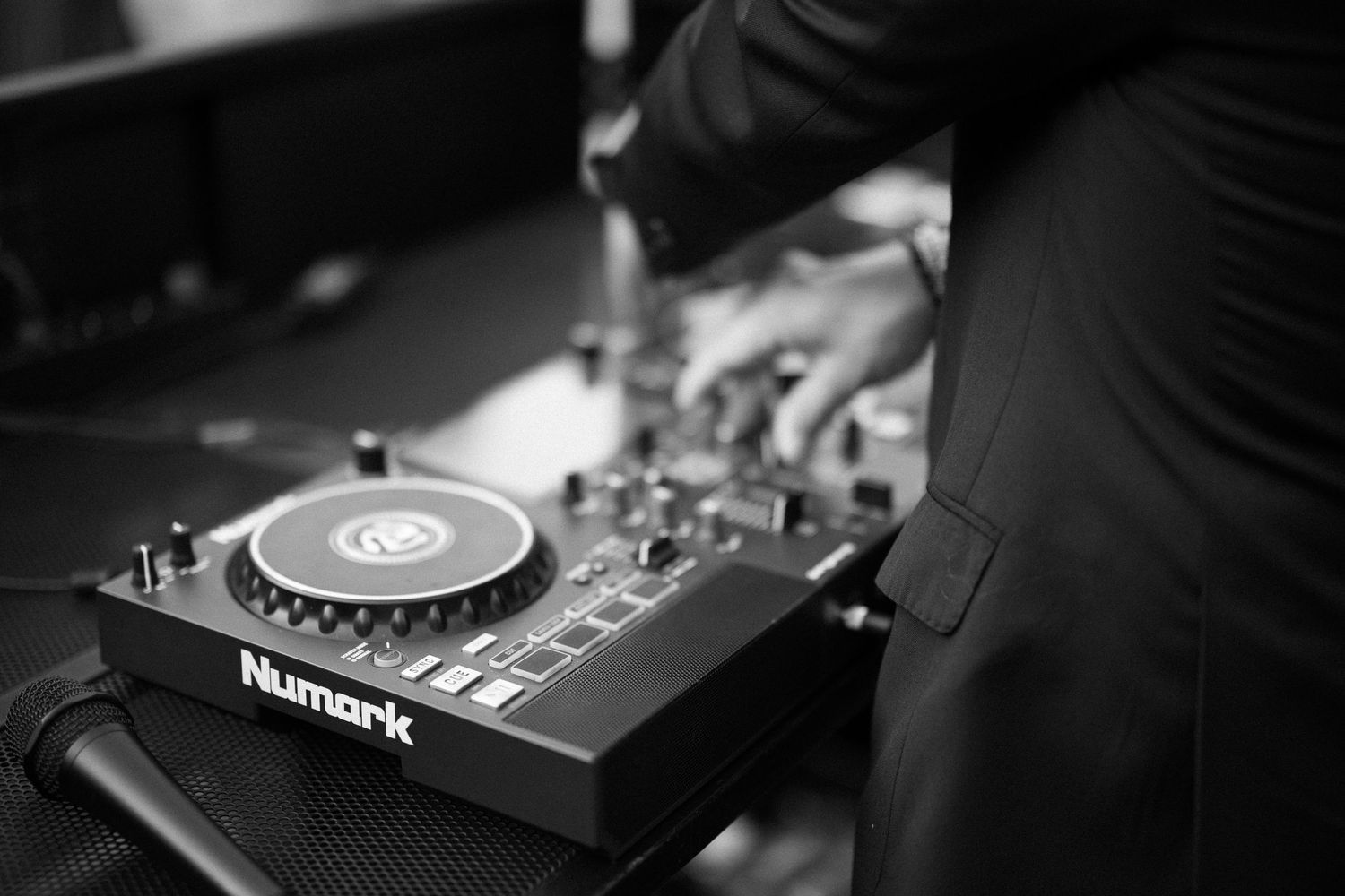 Professional DJ equipment setup showing turntables, mixers and controllers in a dark nightclub environment.