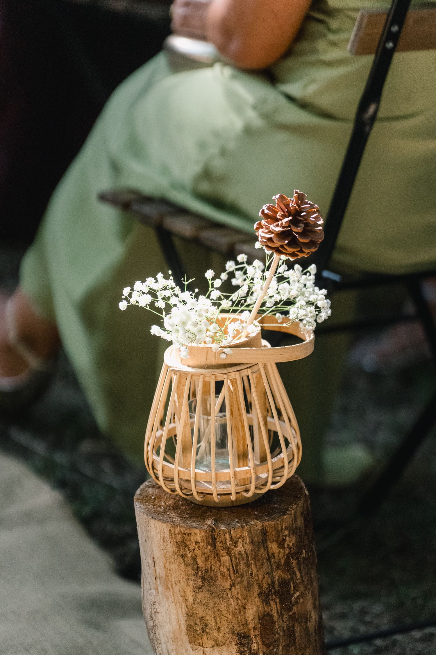 A series of images showing a decorative bamboo basket vase with white flowers placed on a rustic wooden stump.
