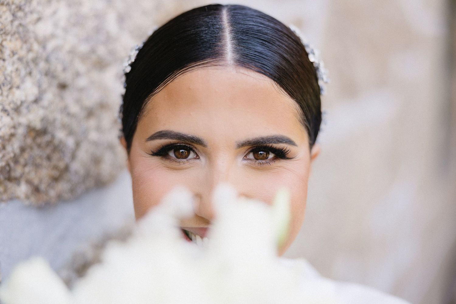 A series of close-up shots showing dark hair styled in an elegant updo with a soft, romantic finish.