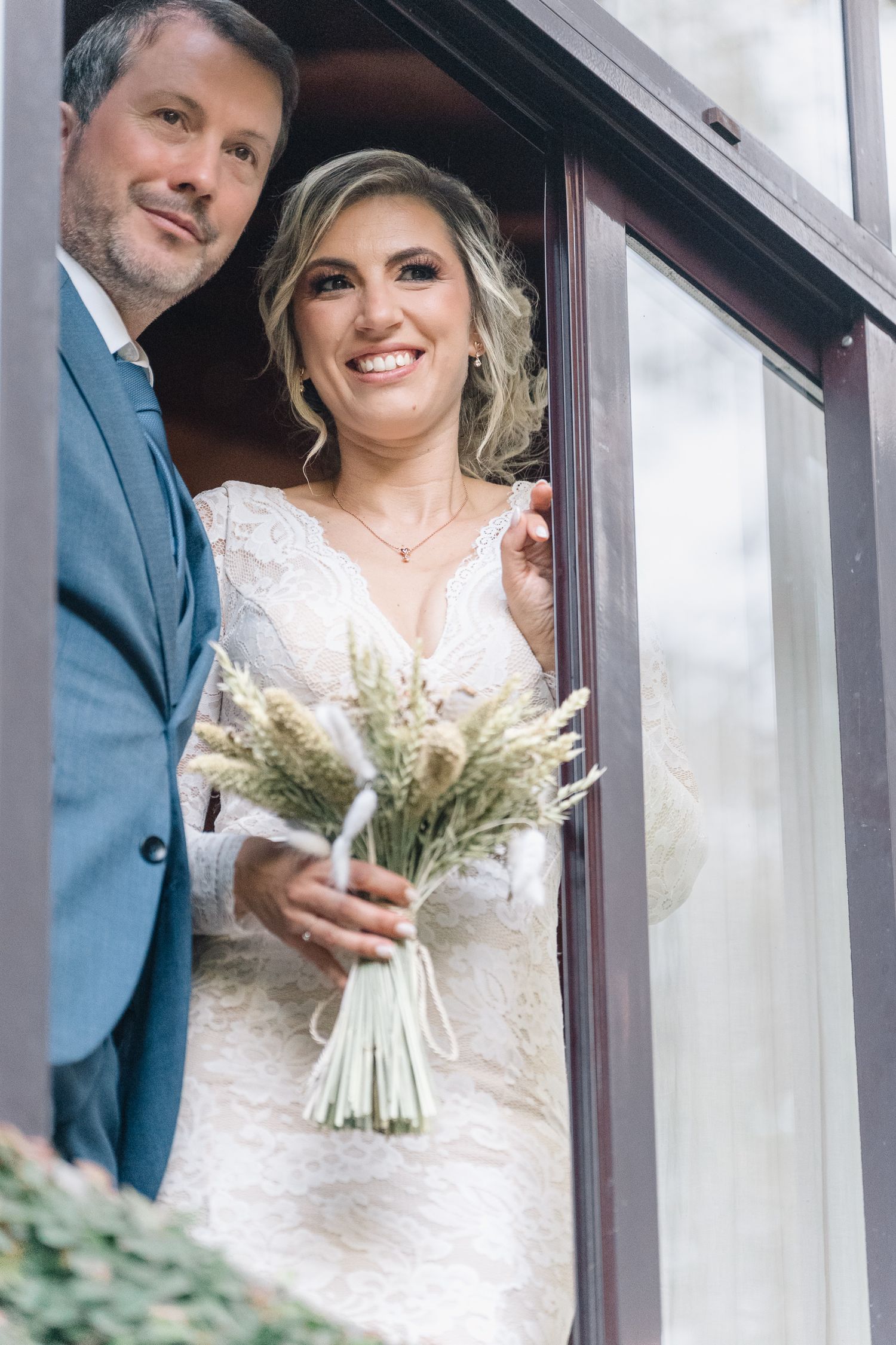 Noivos pousam com um boquet rustico de flores secas e folhagem. Casamento em ponte de lima