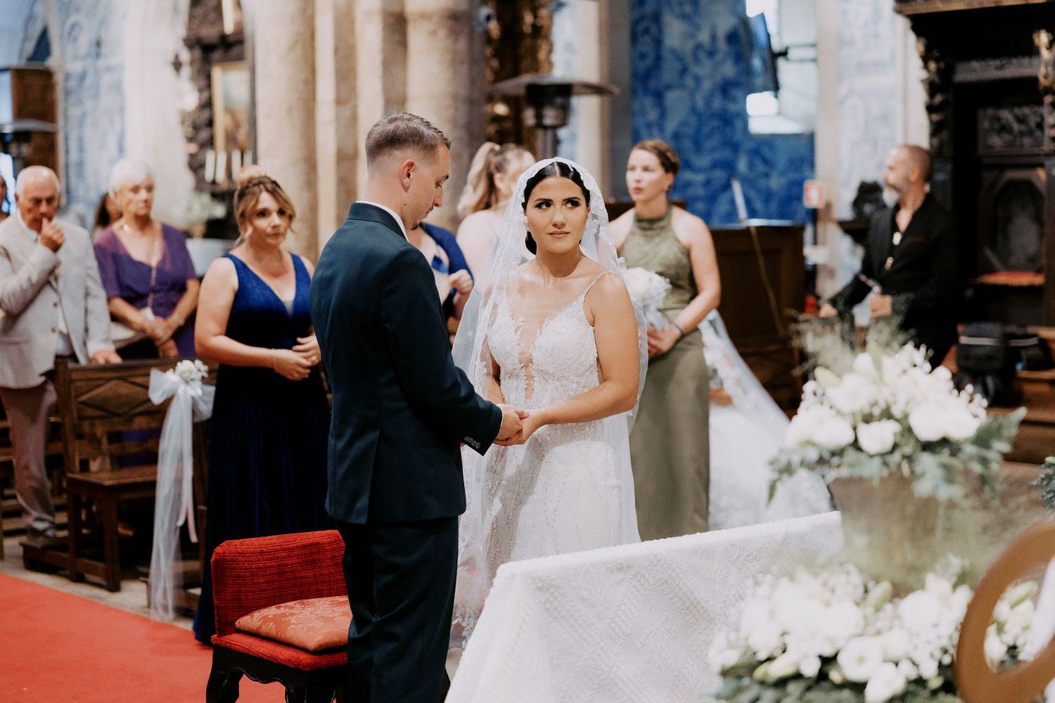 Wedding party celebrates during reception with dancing and candid moments at elegant indoor venue.