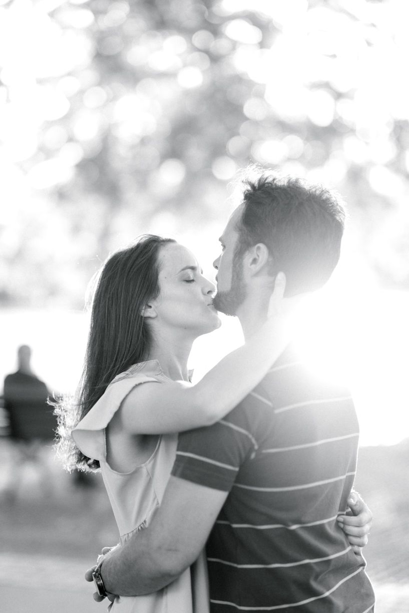 A romantic black and white photo sequence showing a couple embracing in soft natural light.