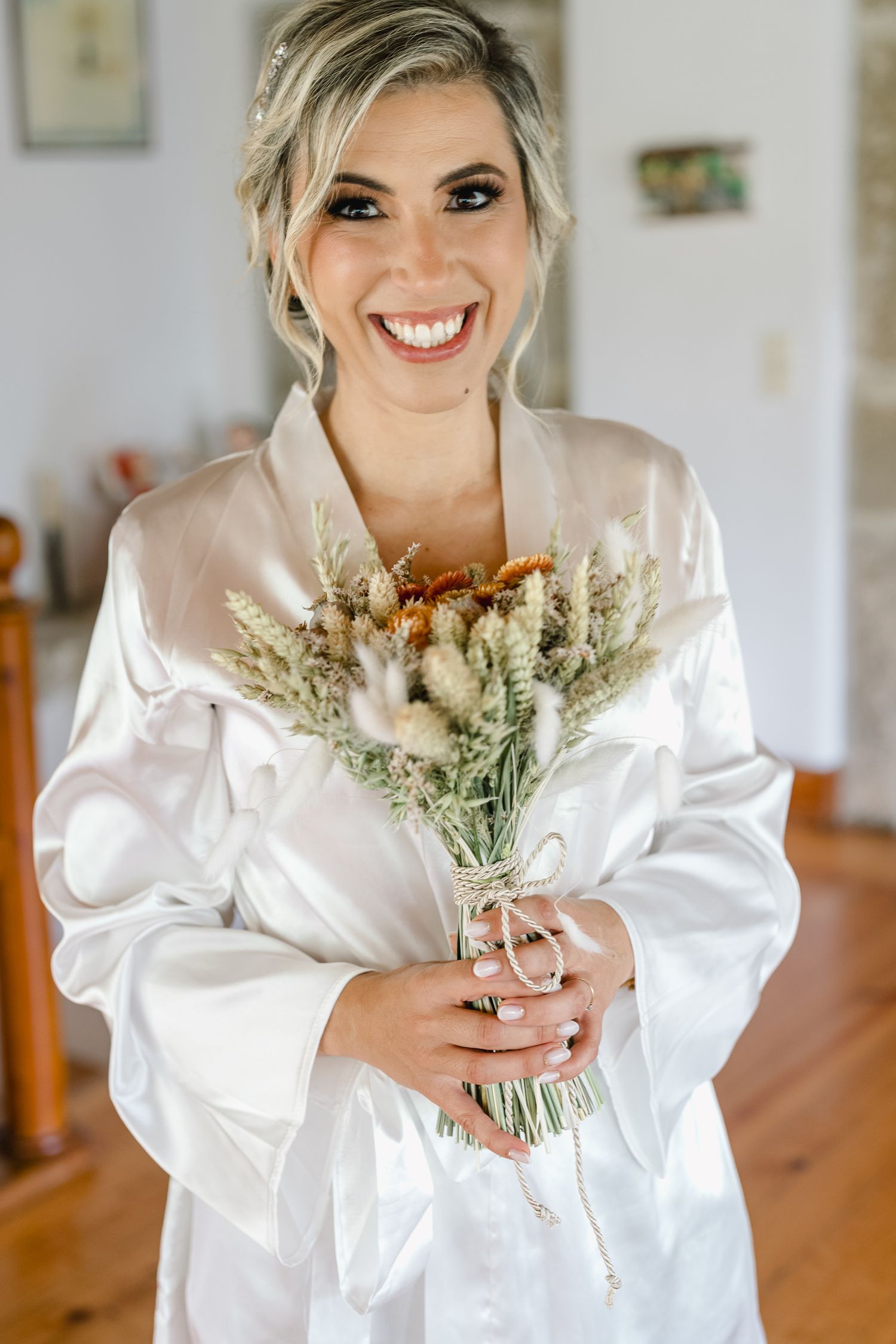 A sequence of wedding preparation photos showing a white satin robe and delicate dried flower bouquet.