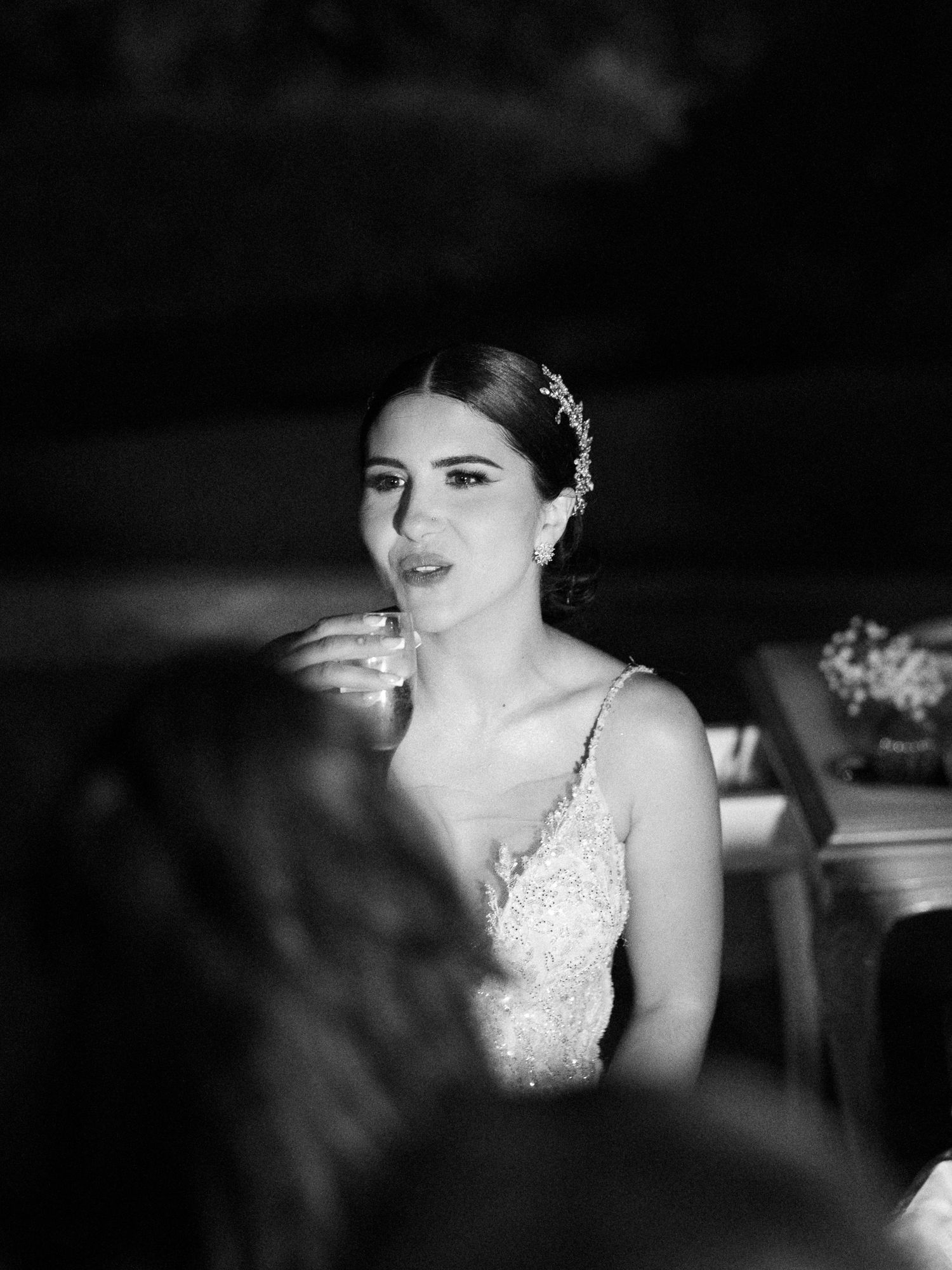 A dramatic black and white sequence of wedding photos showing a bride in a sparkling dress with moody lighting.