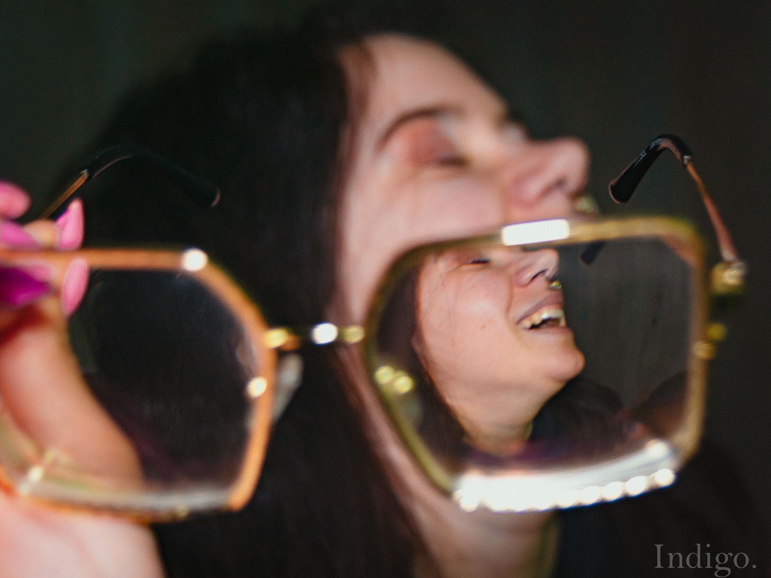 Blurred artistic shot of gold-rimmed glasses in motion.