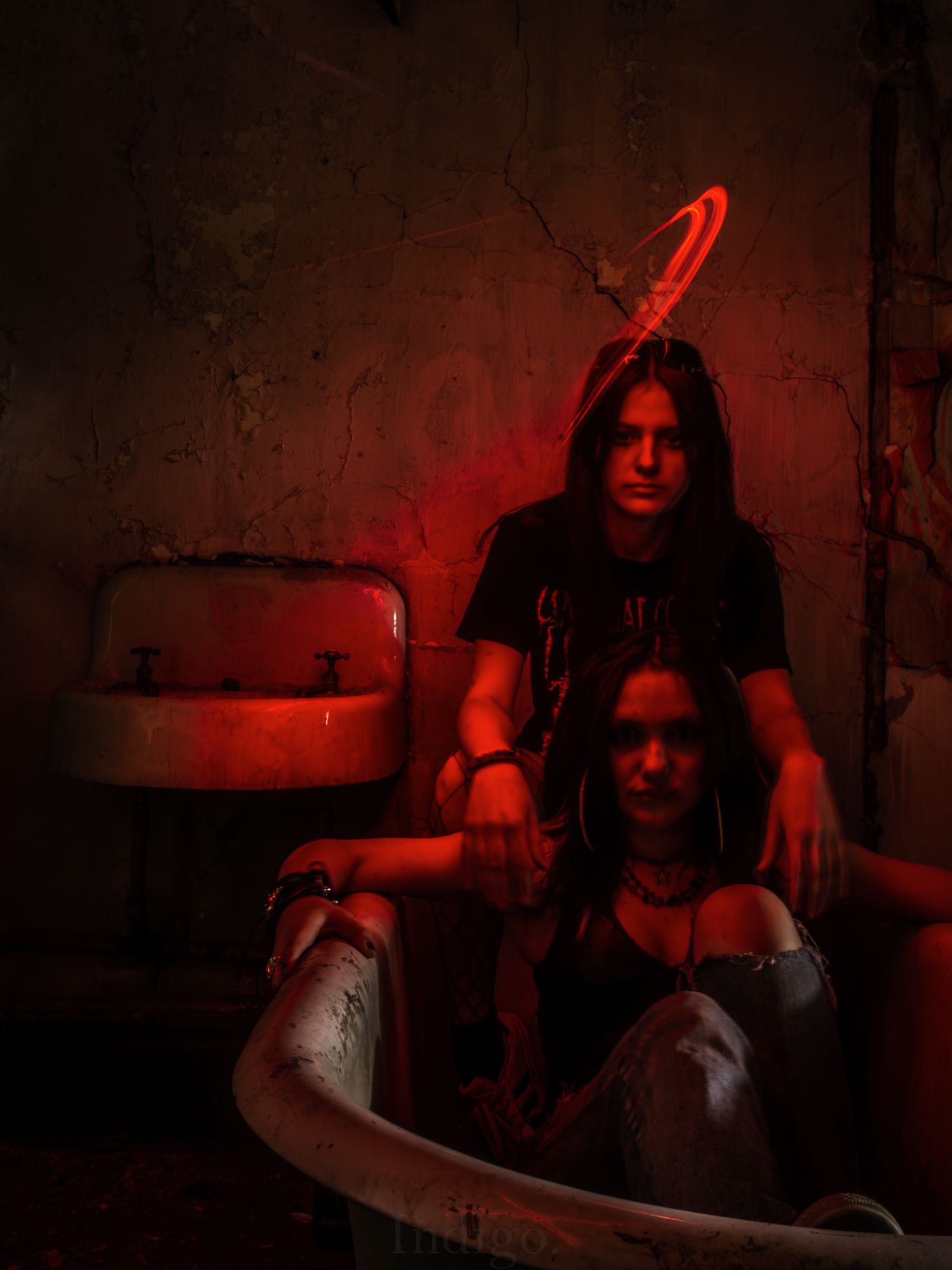 Moody scene with red lighting and guitar in dark atmospheric setting.